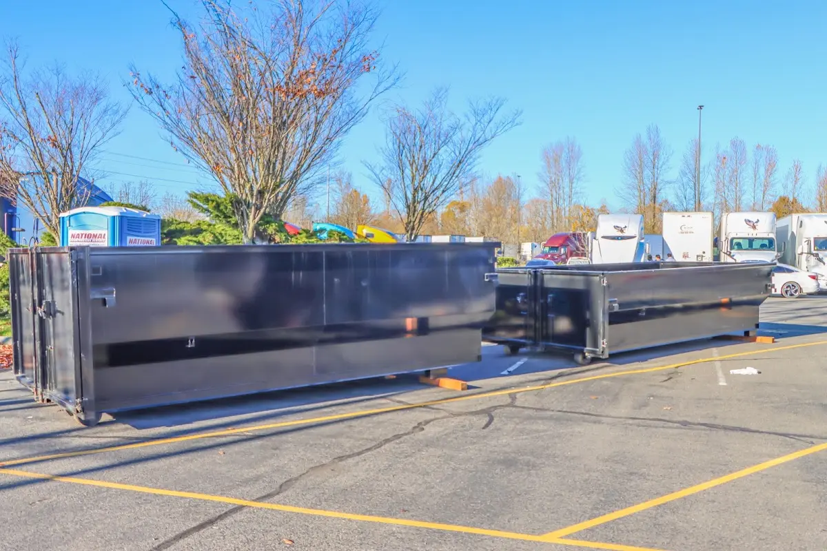 Professional dumpster rental service with roll-off container on residential driveway in Council Bluffs